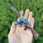 AK-47 Case Hardened miniature held in a hand, showing its 1:5 size
