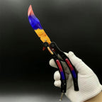 Butterfly Knife Marble Fade trainer held open in a gloved hand