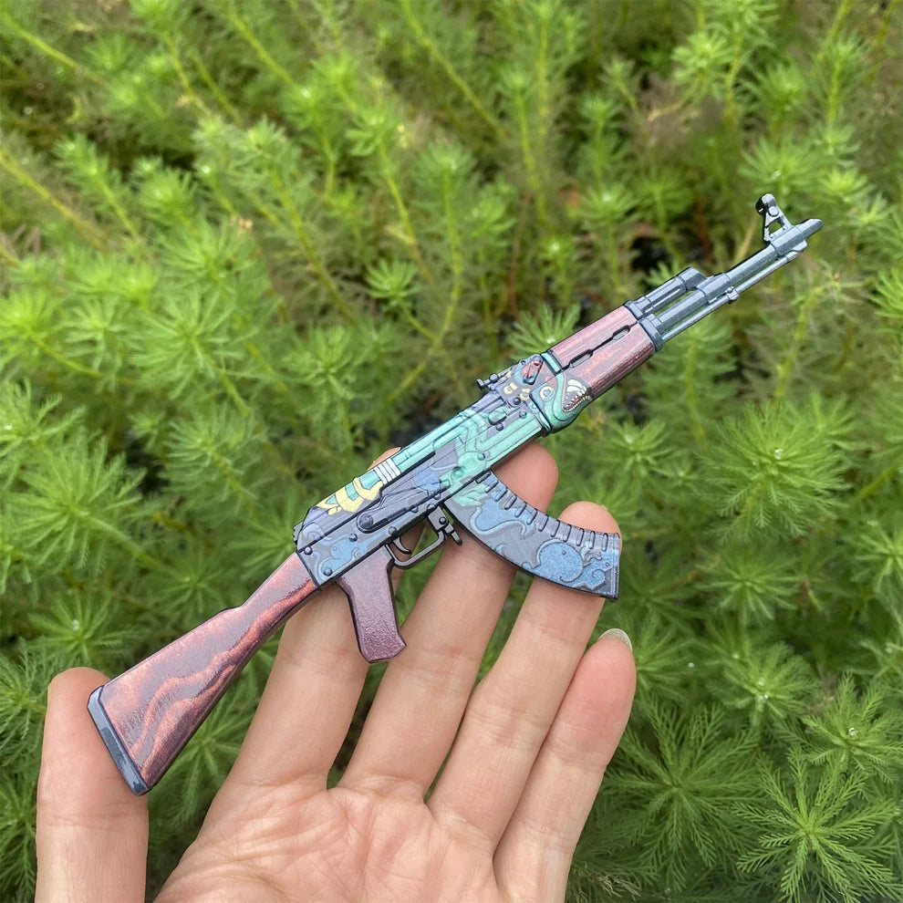 AK-47 Fire Serpent replica held in a hand, showing its 1:5 size